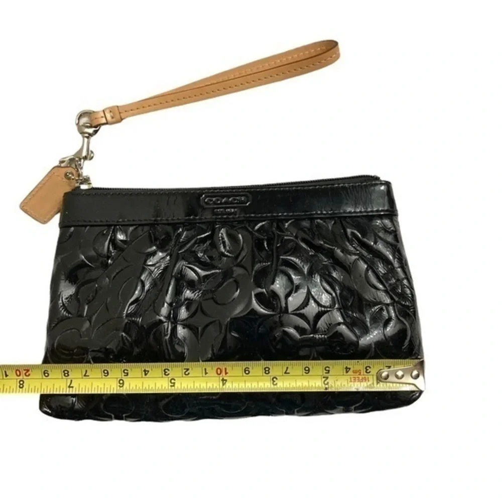 Coach embossed black patent leather op art wristlet bag